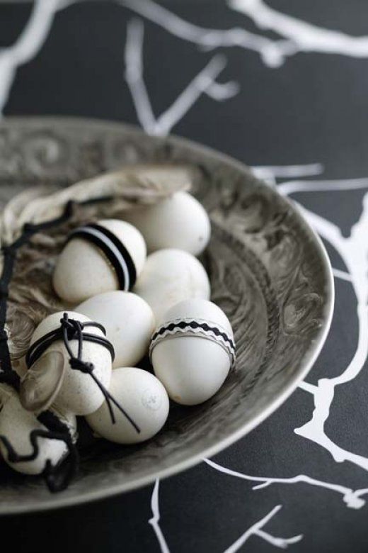 white eggs decorated with twine, yarn and buttons