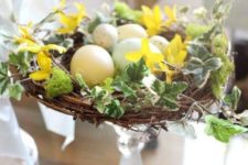 10 a glass stand with a nest, faux leaves and speckled eggs