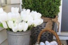 10 white tulips in a bucket and eggs in a basket for a stylish porch