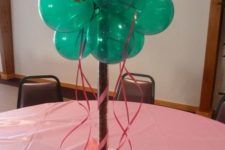 11 a bold emerald balloon centerpiece with a pink owl