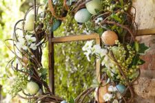 11 an arrangement of faux speckled eggs, ivy and a combination of white floral blooms