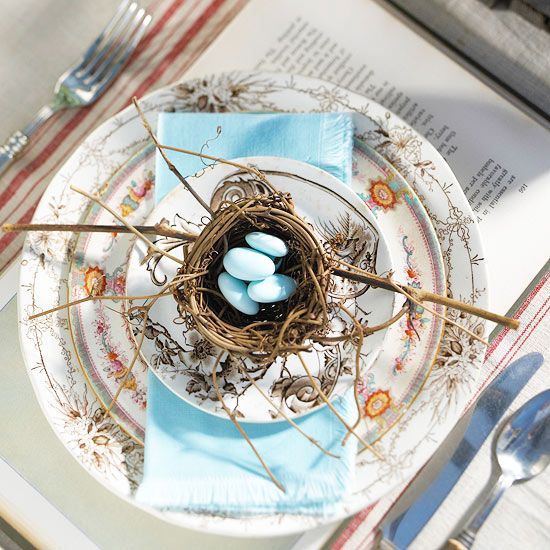 bold patterned plates, a nest with faux blue eggs