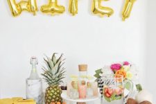 11 gold WIFEY balloons as a fruit table backdrop