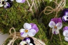 11 moss covered eggs with twine and pansies