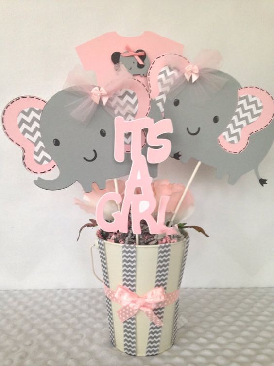 a pink and grey bucket centerpiece with elephant and letter props