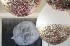 14 glittered and sequined balloons hanging over are great for a bachelorette party