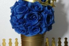 15 a gold bucket with paper roses and a crown for a prince-themed shower