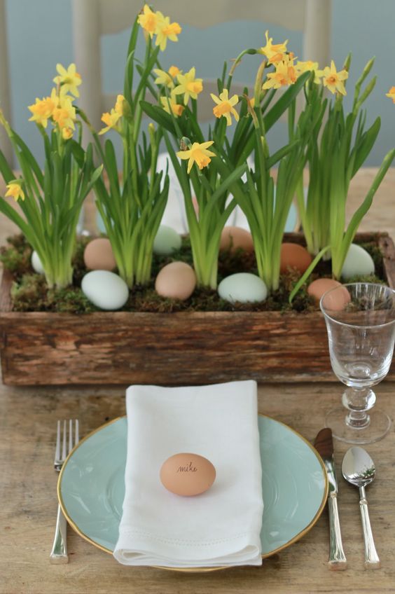 a mint gold edge plate with a white napkin, an egg as a place card