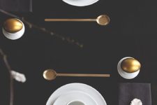 15 black tablecloth, gilded tableware and eggs and white dishes and feathers