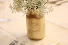 16 a gold mason jar with baby’s breath for a gender neutral shower