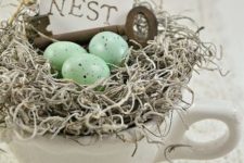 17 a nest in a cup with a vintage key, hay and speckled eggs