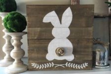 17 a stained pallet sign with a bunny and a nest tail