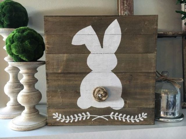 a stained pallet sign with a bunny and a nest tail