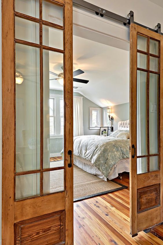 warm wood barn doors with glass panes are cozy and stylish