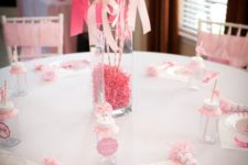 18 sheer balloons with ribbon bows on sticks, a vase with pink paper