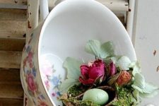 19 a vintage teacup with dried flowers and a small nest with a green egg