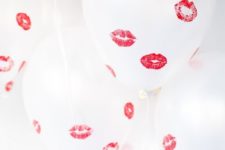 20 take white balloons and kiss them using a red lipstick