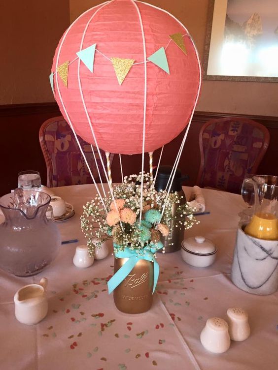 a coral hot air balloon and flowers in a mason jar
