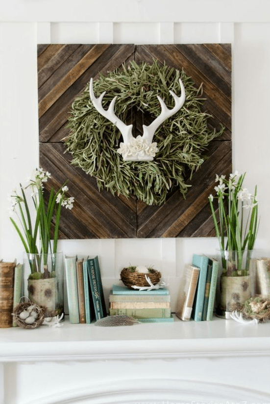 a cute spring mantel with a touch of wild, blooming bulbs, nests with fake eggs and a sign with antlers and a grass wreath