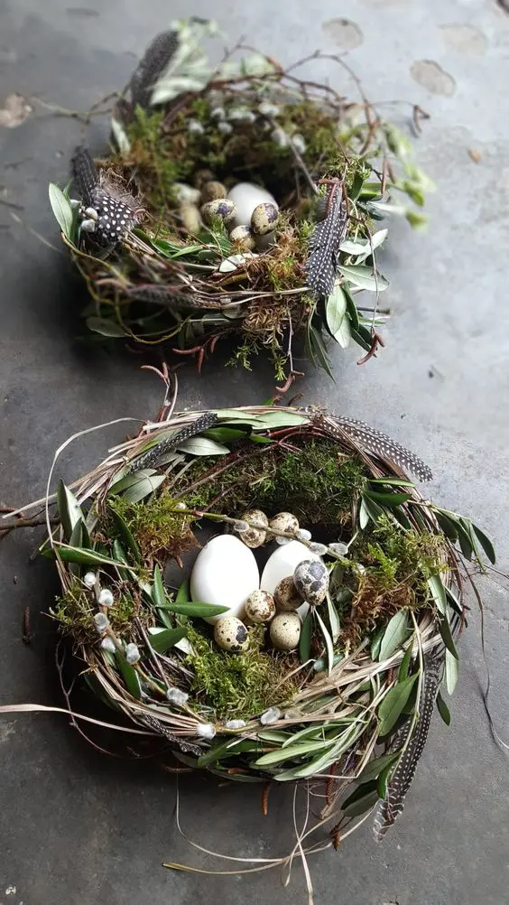 a duo of messy nests with vine, greenery, willow, moss and feathers plus fake eggs inside are great for decor