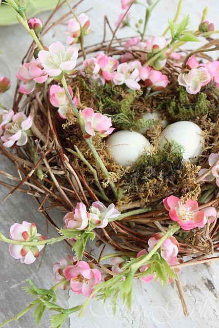 a tender spring nest with moss, faux eggs and pink cherry blossom is a gorgeous indoor and outdoor decoration to rock