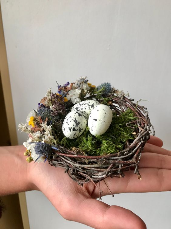 a tiny nest decoration with moss, dried blooms and faux eggs is a pretty idea for spring and Easter