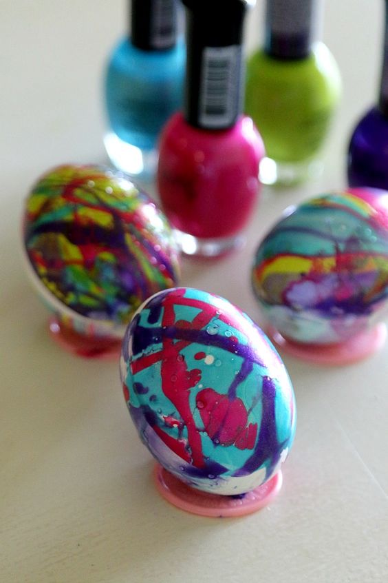 marbelize faux eggs with colorful nail polishes to get colorful Easter decor