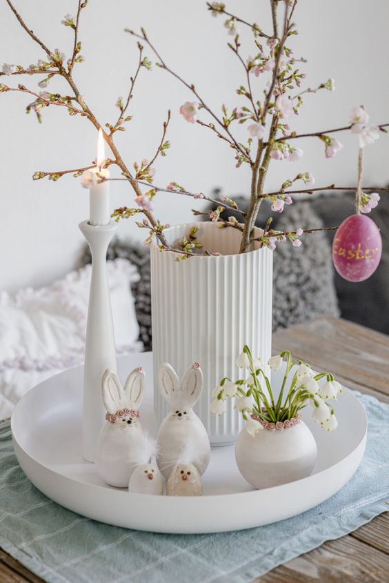modern Easter decor with a tray, a vase with cherry blossom, bunnies and snowdrops in a vase is super cool