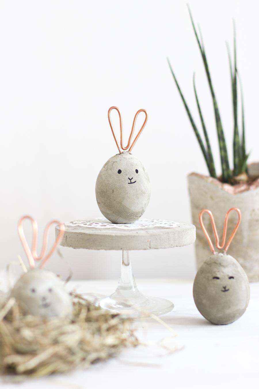DIY concrete egg shaped Easter bunnies with copper wire ears