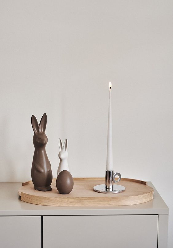 modern to minimalist Easter decor with a tray, a couple of bunnies and an egg plus a single candle is stylish