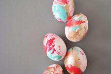 vibrant nail polish marbled Easter eggs can be easily DIYed