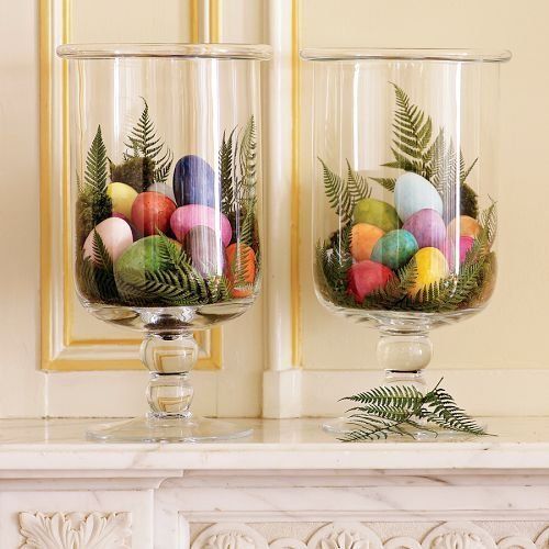glass hurricanes with fern leaves and colorful eggs is a creative idea