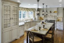 02 off-white cabinets and a backsplash, marble countertops add interest to the kitchen