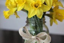 03 a mason jar with a burlap bow and yellow daffodils