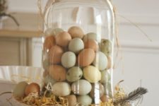 04 a cake stand with straw and naturally dyed eggs in a ball jar