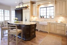 04 a dark cabinet and kitchen island help the cream colored kitchen stand out