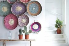 06 a boho ethnic entryway is decorated with colorful wall baskets and rugs