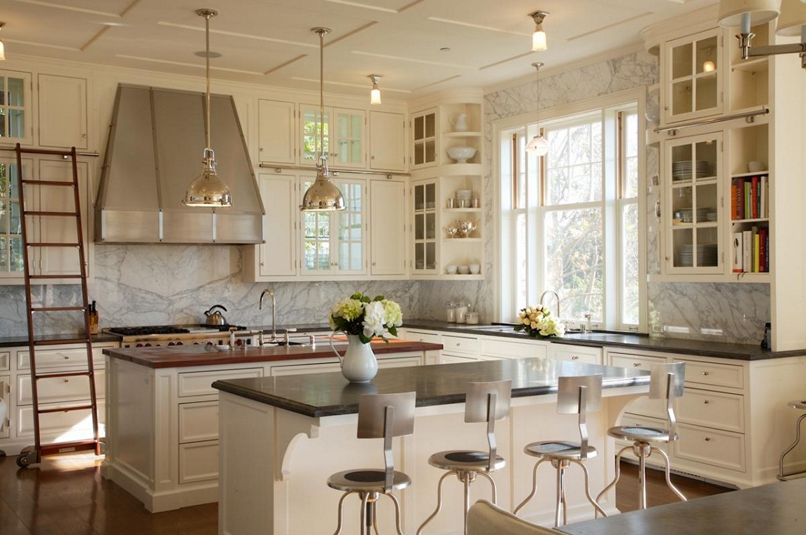 White and off whites are spruced up with a marble backsplash and wall