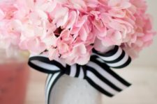 08 a neutral vase with a striped black and white bow and pink flowers