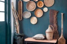 08 a teal wall and cool baskets that echo with a jute rug and a cork bench