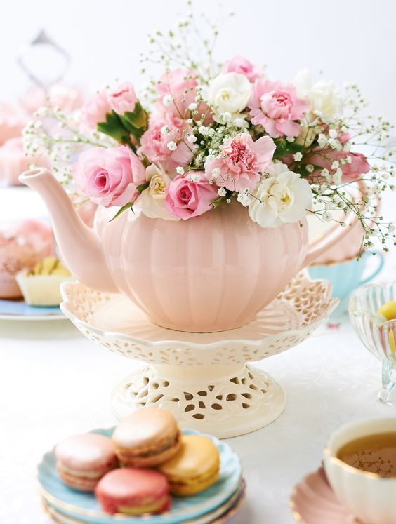 a blush tea pot with delicate and sweet flowers on a vintage stand