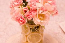09 a jar filled with lemon slices and blush and pink flowers