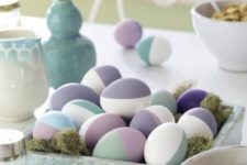 10 a pale blue wooden tray with moss and colored modern eggs