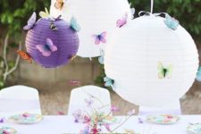 10 paper lanterns with butteflies over the table