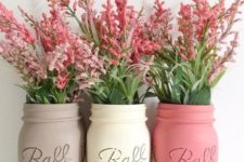 10 tied up mason jars in soft shades with simple flowers