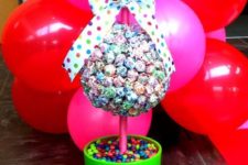 11 a double lollipop topiary in a pot filled with candies