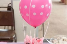 11 a pink polka dot centerpiece with plastic tableware is functional