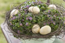 12 a bowl with greenery and flowers, with pastel eggs and twigs