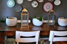 12 mismatching colorful plates on a dining room wall