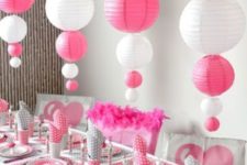 12 pink and white paper balloon vertical garlands over the table